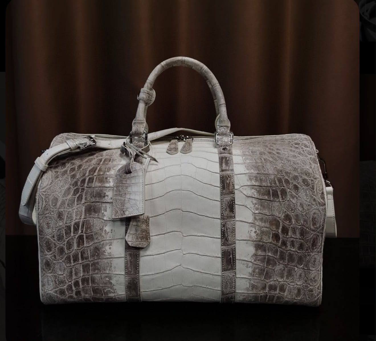 NEESO crocodile-leather duffel on marble